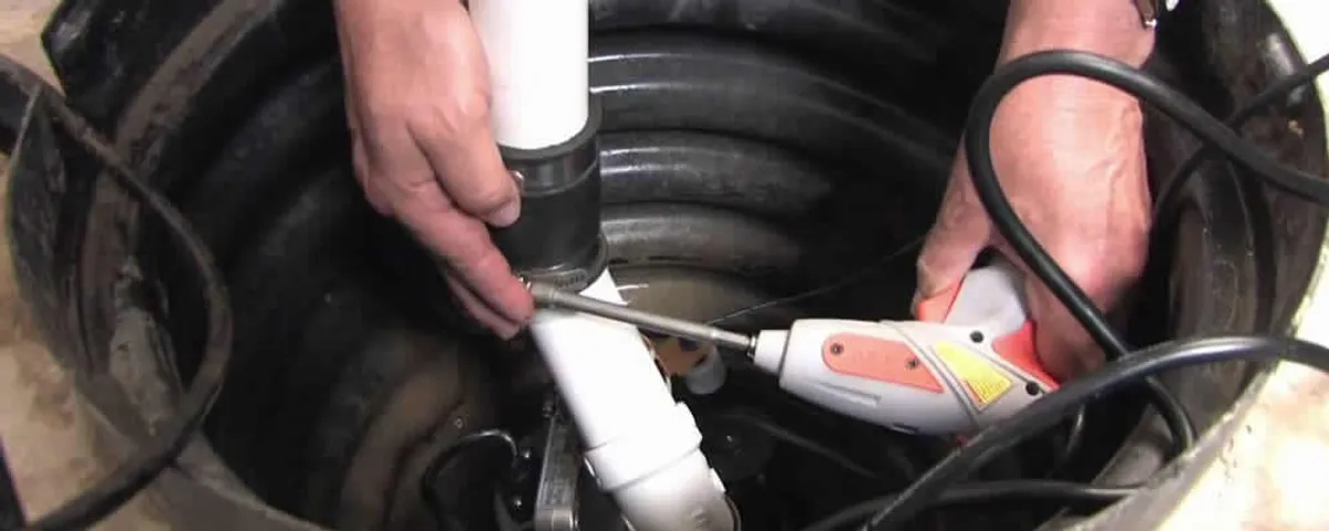 Sump pump installation technician connecting PVC discharge piping in Mountain View, CA